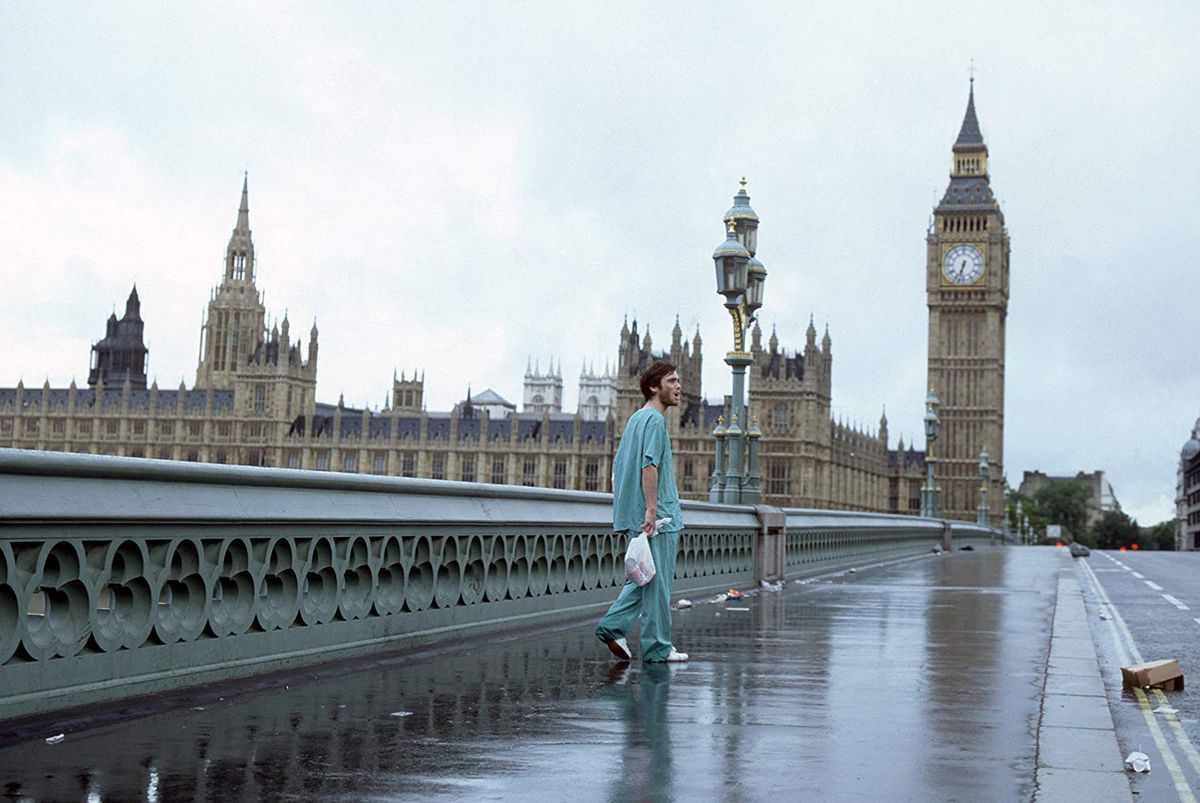 Jim (Cillian Murphy) walks down a deserted London street wearing scrubs