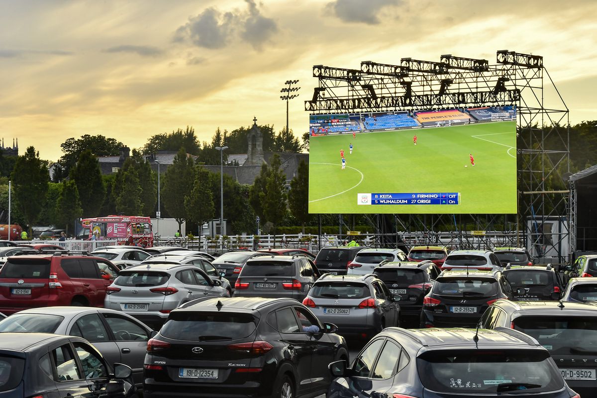 Irish supporters watch the Merseyside derby from a Drive In Theatre in Dublin