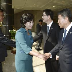 In this photo released by the South Korean Unification Ministry, the head of North Korea's delegation Kim Song Hye, center, shakes hands with South Korean delegate Kwon Young-yang, right, as South Korea's Unification Policy Officer Chun Hae-sung, second from right, shakes hands with an unidentified North Korean officer, left, upon their arrival for a meeting at the southern side of Panmunjom, which has separated the two Koreas since the Korean War, in Paju, north of Seoul, South Korea, Sunday, June 9, 2013. Government delegates from North and South Korea began preparatory talks Sunday at the "truce village" on their heavily armed border aimed at setting ground rules for a higher-level discussion on easing animosity and restoring stalled rapprochement projects.(AP Photo/South Korean Unification Ministry)
