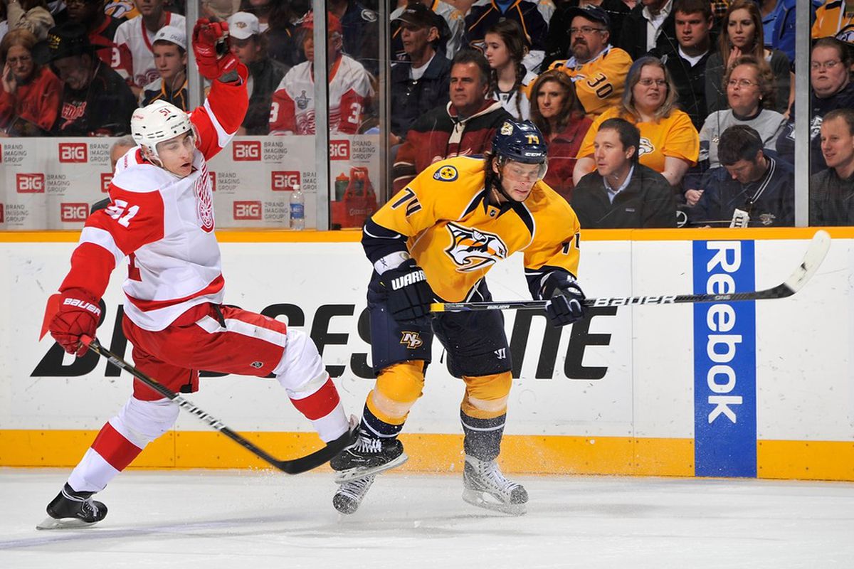 NASHVILLE, TN - MARCH 10:  Valtteri Filppula #51 of the Detroit Red Wings bounces off of Sergei Kostitsyn #74 of the Nashville Predators at Bridgestone Arena on March 10, 2012 in Nashville, Tennessee.  (Photo by Frederick Breedon/Getty Images)