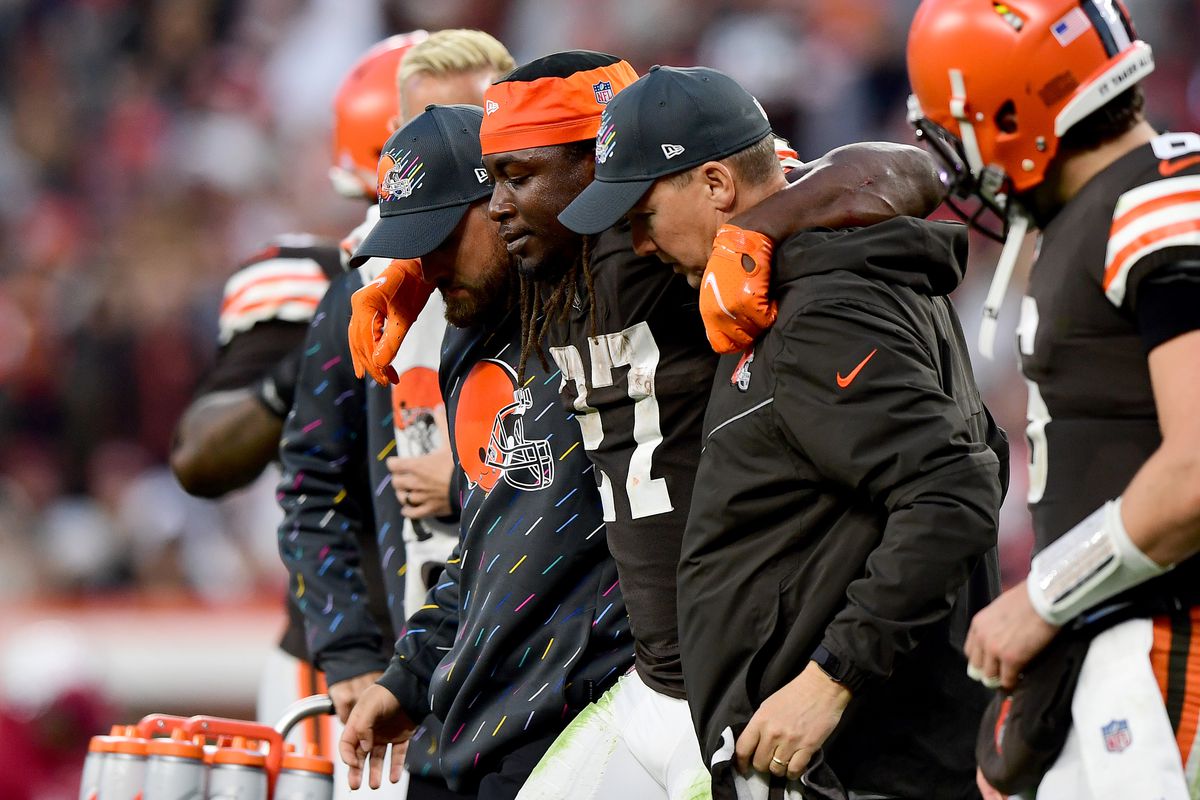 Kareem Hunt #27 of the Cleveland Browns is helped off the field by team medical personnel after an injury during the fourth quarter against the Arizona Cardinals at FirstEnergy Stadium on October 17, 2021 in Cleveland, Ohio.