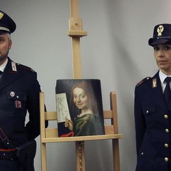 Carabinieri and police officers pose with one of the recovered paintings that were stolen  from a Verona museum, at the Verona airport, Italy, Wednesday, Dec. 21, 2016. Italy’s culture minister has traveled to Kiev to recover 17 paintings,  including works by Tintoretto, Rubens and Mantegna, that were stolen from a Verona museum and recovered by Ukrainian law enforcement more than seven months ago. Culture Minister Dario Franceschini and Verona Mayor Flavio Tosi traveled to retrieve the paintings. 