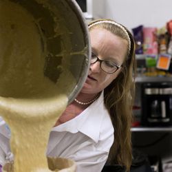 Leslie Fiet, owner of Mini's Gourmet Cupcakes, pours batter while making cupcakes at her shop in Salt Lake City on Friday, Feb. 6, 2015. Fiet rescued a kidnapped 3-year-old girl on Wednesday evening, and the shop has been busy customers since then.
