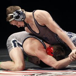 Bryce Brimhall of Syracuse, bottom, and Tanner Benedict of Layton compete at the 5A State Wrestling Championships at UVU in Orem Thursday, Feb. 12, 2015.