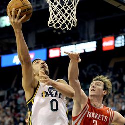 Utah Jazz center Enes Kanter (0) gets a basket past the arm of Houston Rockets center Omer Asik (3) during a game at EnergySolutions Arena on Monday, Dec. 2, 2013.