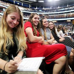 A group of young women sit in their seats at a devotional with President Russell M. Nelson and others at the Amway Center in Orlando, Florida, on Sunday, June 9, 2019.