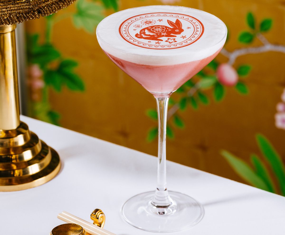 A cocktail with a red image of a rabbit on top.