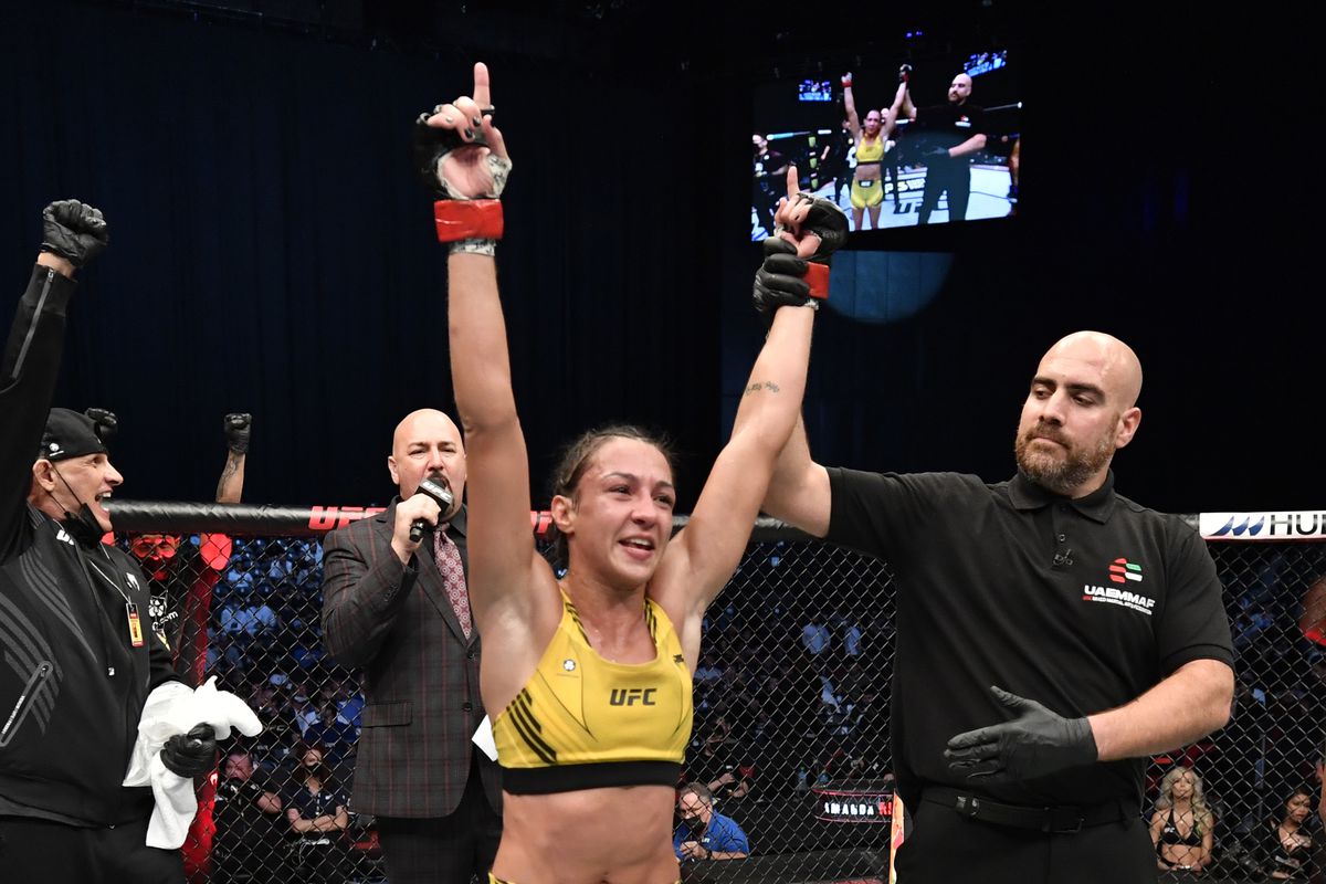 Amanda Ribas celebrates after her victory over Virna Jandiroba in a strawweight fight at UFC 267.