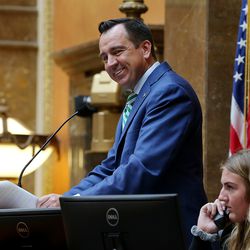House Speaker Greg Hughes,R-Draper, smiles as Rep. Brad Daw, R-Orem, presents a resolution honoring Outgoing Utah Valley University President Matthew S. Holland on the House floor at the Capitol in Salt Lake City on Monday, Feb. 26, 2018.  The House and Senate unanimously passed a resolution honoring Holland, who is resigning from the Orem-based school to become an LDS Church mission president in North Carolina.