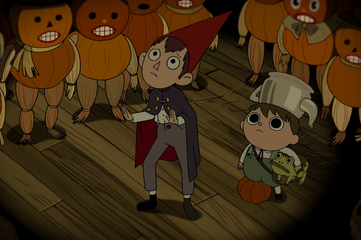 Wirt and Greg, surrounded by pumpkin people, plead with a giant pumpkin spirit.