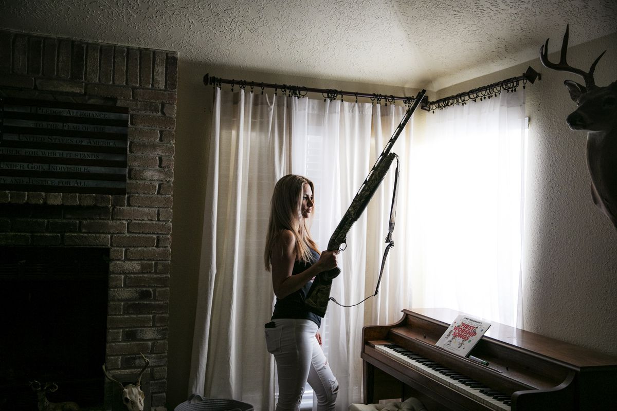 Liberte Austin poses for a photograph in her living room holding a&nbsp;Camo Shotgun Beretta A400 Max in 12 gauge.