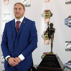 File-This Dec. 8, 2016 file photo shows Utah punter Mitch Wishnowsky, of Australia, standing next to the the Ray Guy Award after being named the top punter in college football,in Atlanta. Wishnowsky was named to the AP Preseason All-America Team on Tuesday, Aug. 22, 2017. 
