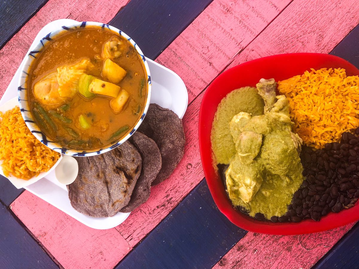 An overhead picture of Tierra del Sol’s mole amarillo on the left and mole verde on the right