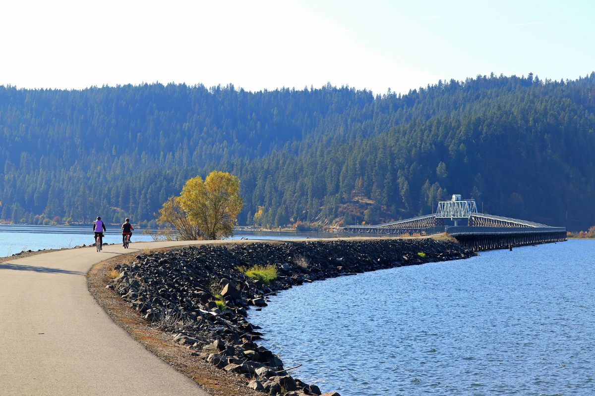 Bikers on the Chatcolet Lake biking and hiking bridge crossing lake in northern Idaho