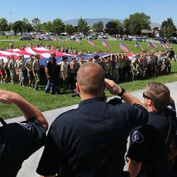 FILE - Scouts and Cub Scouts support a giant American flag as American Fork City marks the completion of an 18 month Memorial Garden project at the city cemetery Tuesday, June 14, 2016.