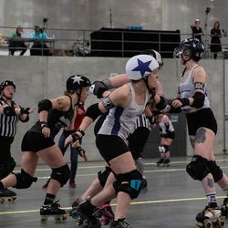 Ann Arbor’s jammer and Windy City’s jammer are neck and neck as they try to get past the opposing teams blockers. Annie Costabile/Sun-Times
