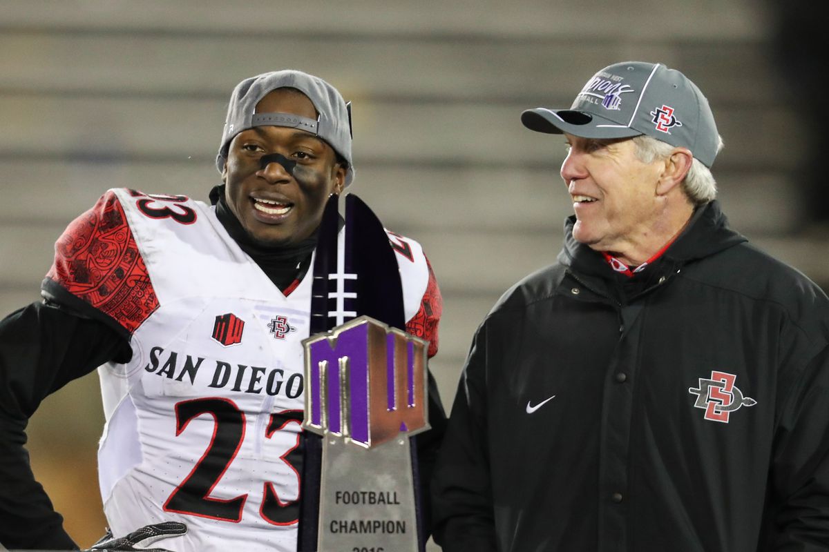 San Diego State Damontae Kazee and head coach Rocky Long accept trophy after game against Wyoming at the Mountain West Championship college football game.