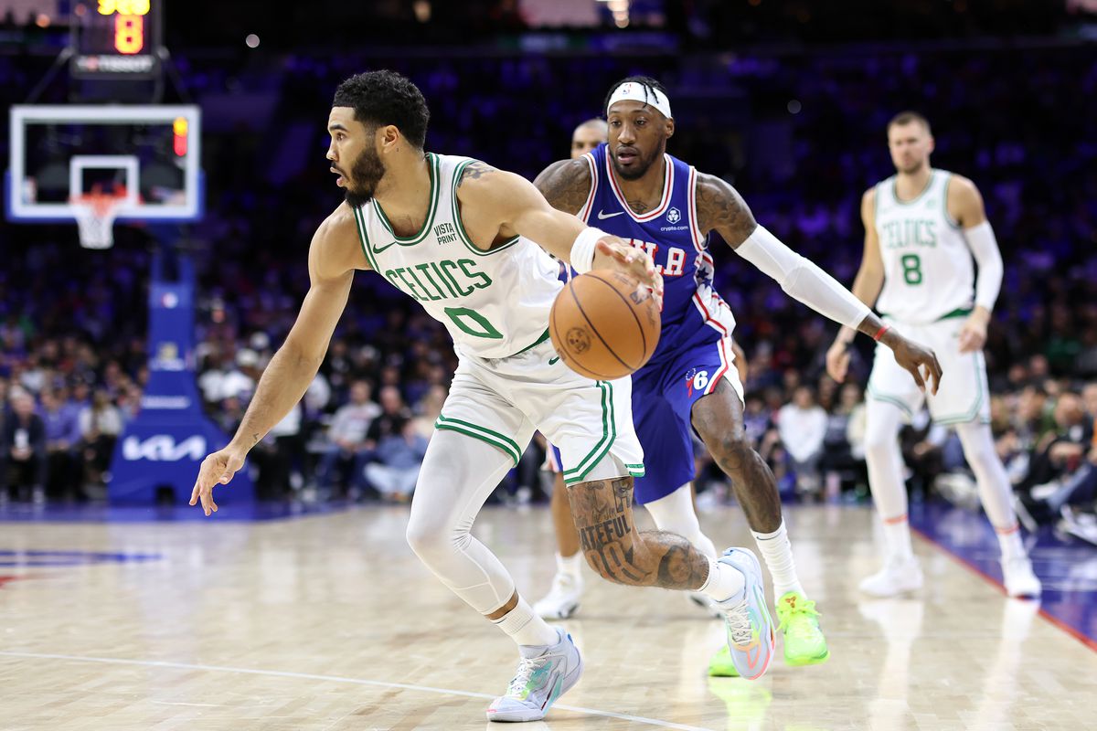 Jayson Tatum of the Boston Celtics drives past Robert Covington of the Philadelphia 76ers during the fourth quarter at the Wells Fargo Center on November 08, 2023 in Philadelphia, Pennsylvania.