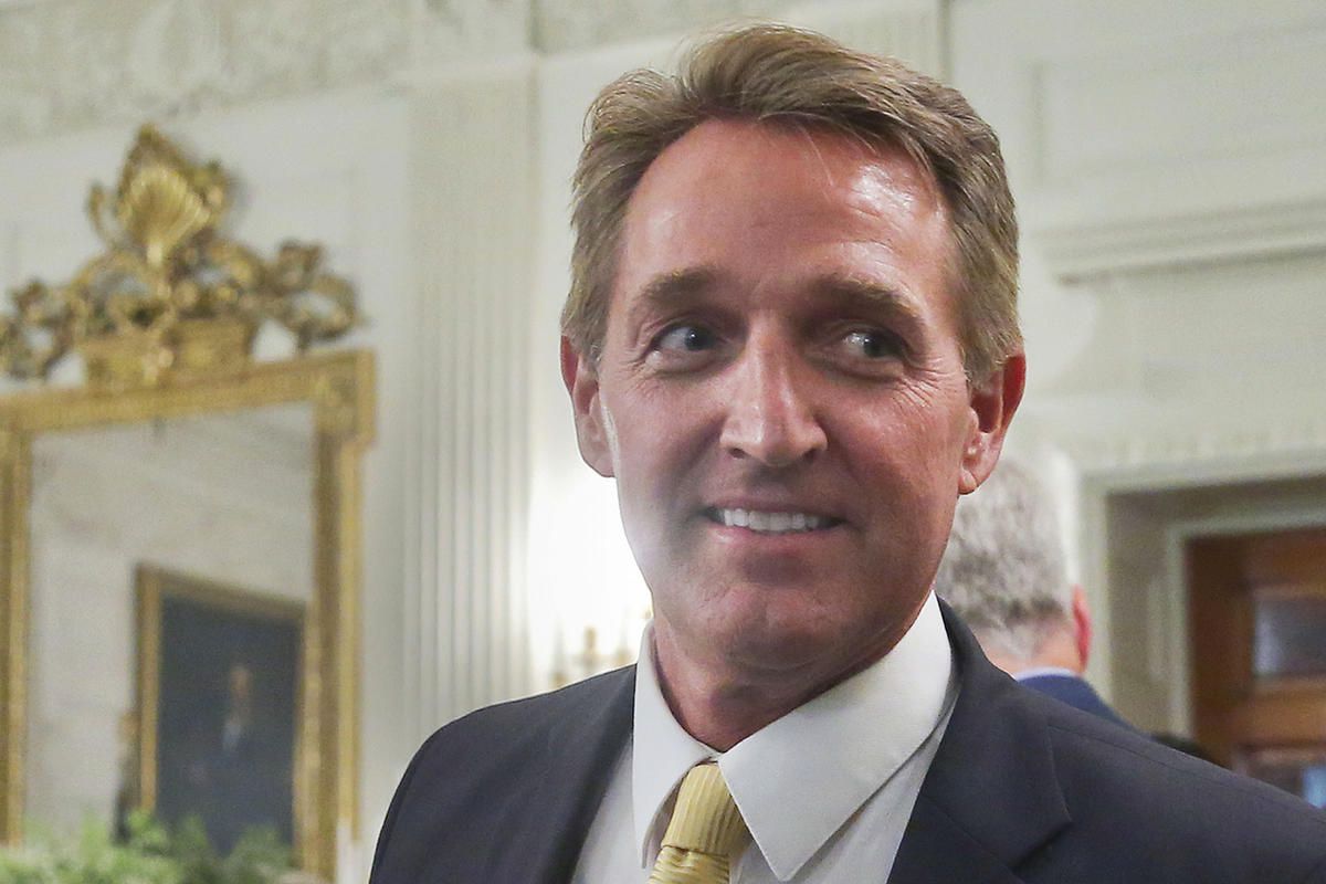 FILE - In this July 19, 2017 photo, Sen. Jeff Flake, R-Ariz. walks to his seat as he attends a luncheon with other GOP Senators and President Donald Trump at the White House in Washington. Flake’s re-election race is becoming a case study in the GOP’s con