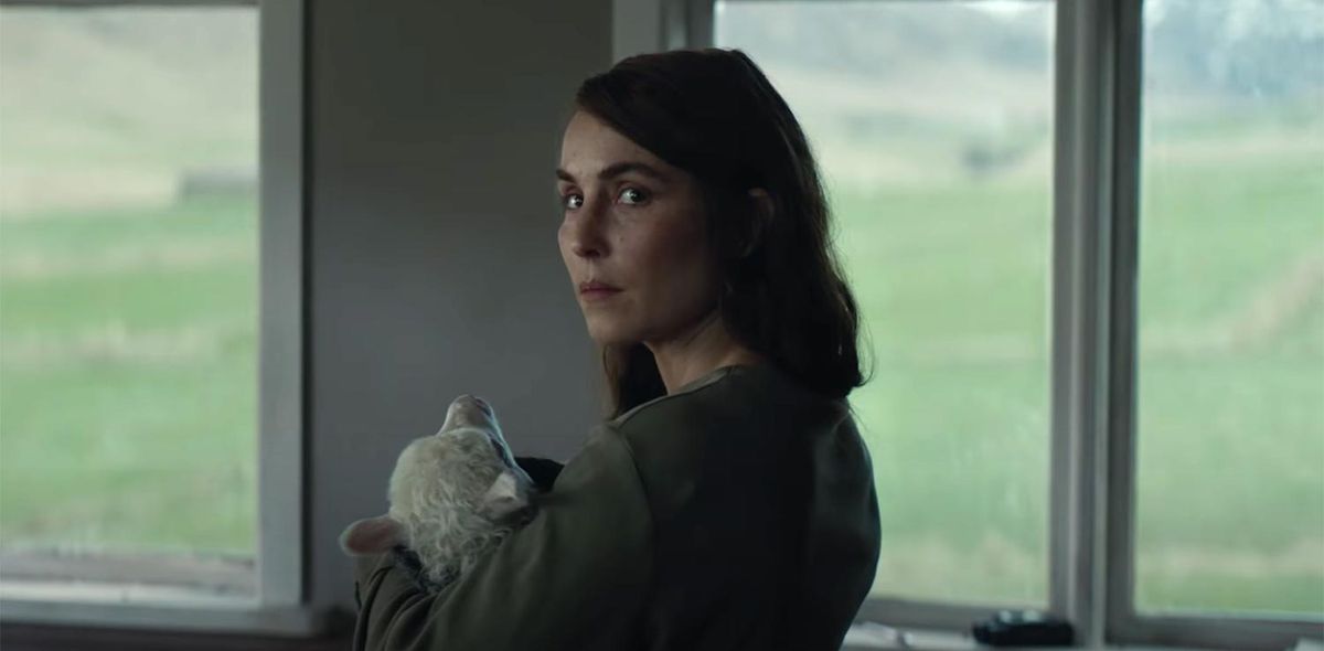 Noomi Rapace holding a lamb-headed child in Lamb