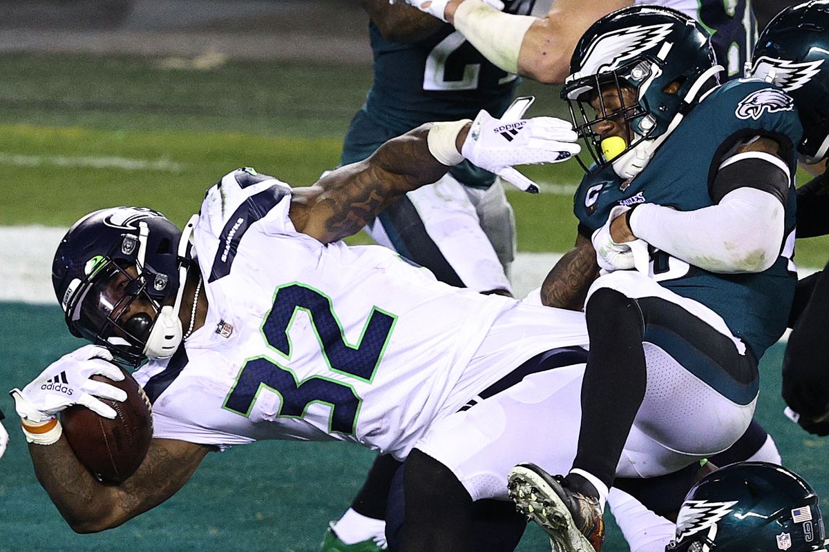 Chris Carson #32 of the Seattle Seahawks scores a touchdown against Rodney McLeod #23 of the Philadelphia Eagles during the second quarter at Lincoln Financial Field on November 30, 2020 in Philadelphia, Pennsylvania.