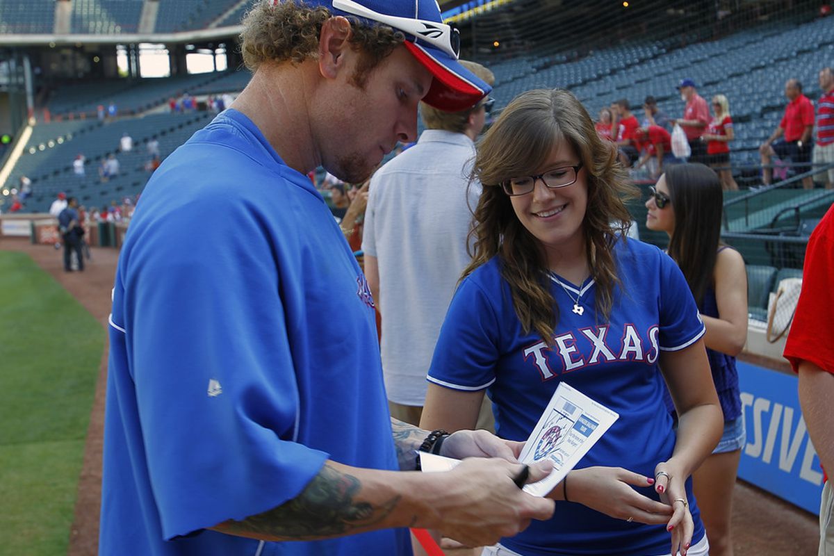 ARLINGTON, TX - MAY 16: Josh Hamilton #32 of the Texas Rangers signs autographs before the game against the Oakland Athletics at Rangers Ballpark in Arlington on May 16, 2012 in Arlington, Texas. (Photo by Rick Yeatts/Getty Images)