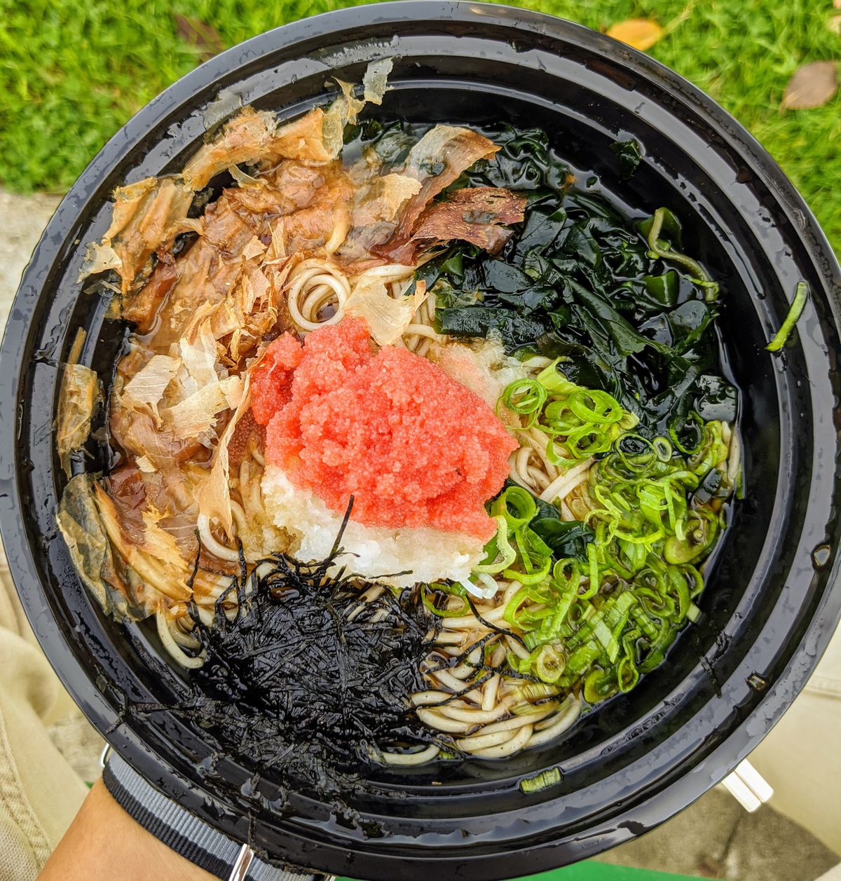 Mentai oroshi soba bowl at Ichimiann in a black plastic bowl.