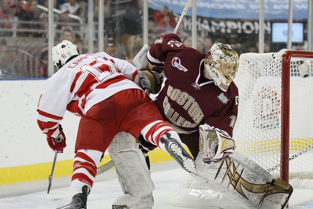 Carter Camper #11 of the Miami Redhawks is knocked over by John Muse #1 of the Boston College Eagles on April 8, 2010 during the semifinals of the 2010 NCAA Frozen Four at Ford Field in Detroit, Michigan.  (Photo by Elsa/Getty Images)