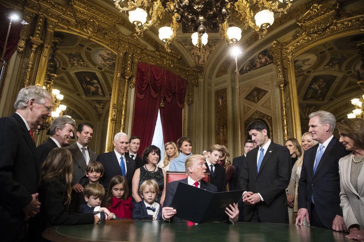 President Donald Trump is joined by the Congressional leadership, Speaker of the House Paul Ryan is to his left, and his family, as he formally signs his cabinet nominations into law.