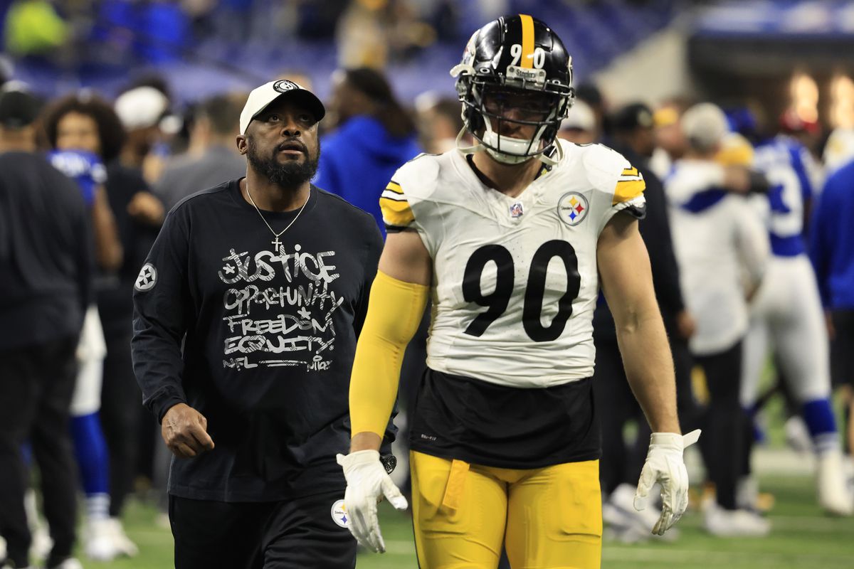 Head coach Mike Tomlin and T.J. Watt #90 of the Pittsburgh Steelers walk off the field after a loss to the Indianapolis Colts at Lucas Oil Stadium on December 16, 2023 in Indianapolis, Indiana.