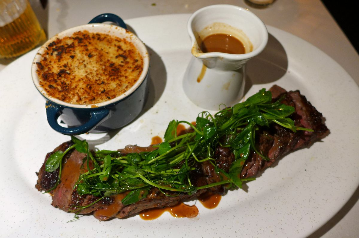 A long steak smothered in watercress.