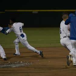 DJ Burt (#8) trying to outrun a second ice-cold splash after he hit a game-winning sac fly in the 9th inning.