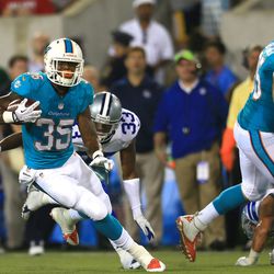 Aug 4, 2013; Canton, OH, USA; Miami Dolphins running back Mike Gillislee (35) runs the ball in the second quarter of the 2013 Pro Football Hall of Fame game against the Dallas Cowboys at Fawcett Stadium.