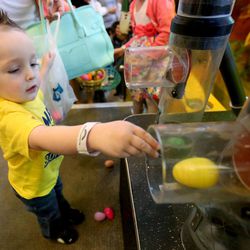 Grayson Harrison reaches for an egg during Make-A-Wish Utah's annual Easter egg hunt for children facing life-threatening medical conditions at the Discovery Gateway Museum in Salt Lake City on Saturday, March 19, 2016. 