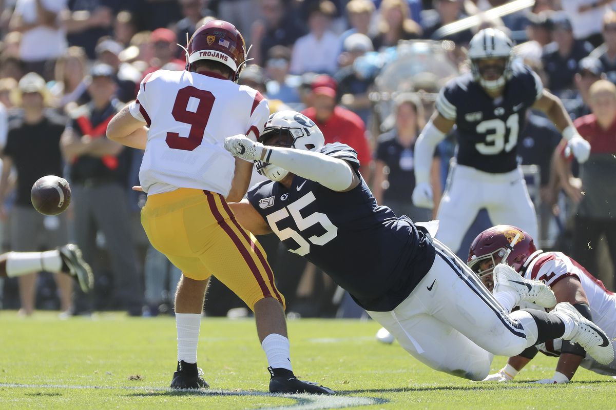 Brigham Young Cougars defensive lineman Lorenzo Fauatea (55) sacks and strips the ball from USC Trojans quarterback Kedon Slovis (9) in Provo on Saturday, Sept. 14, 2019.