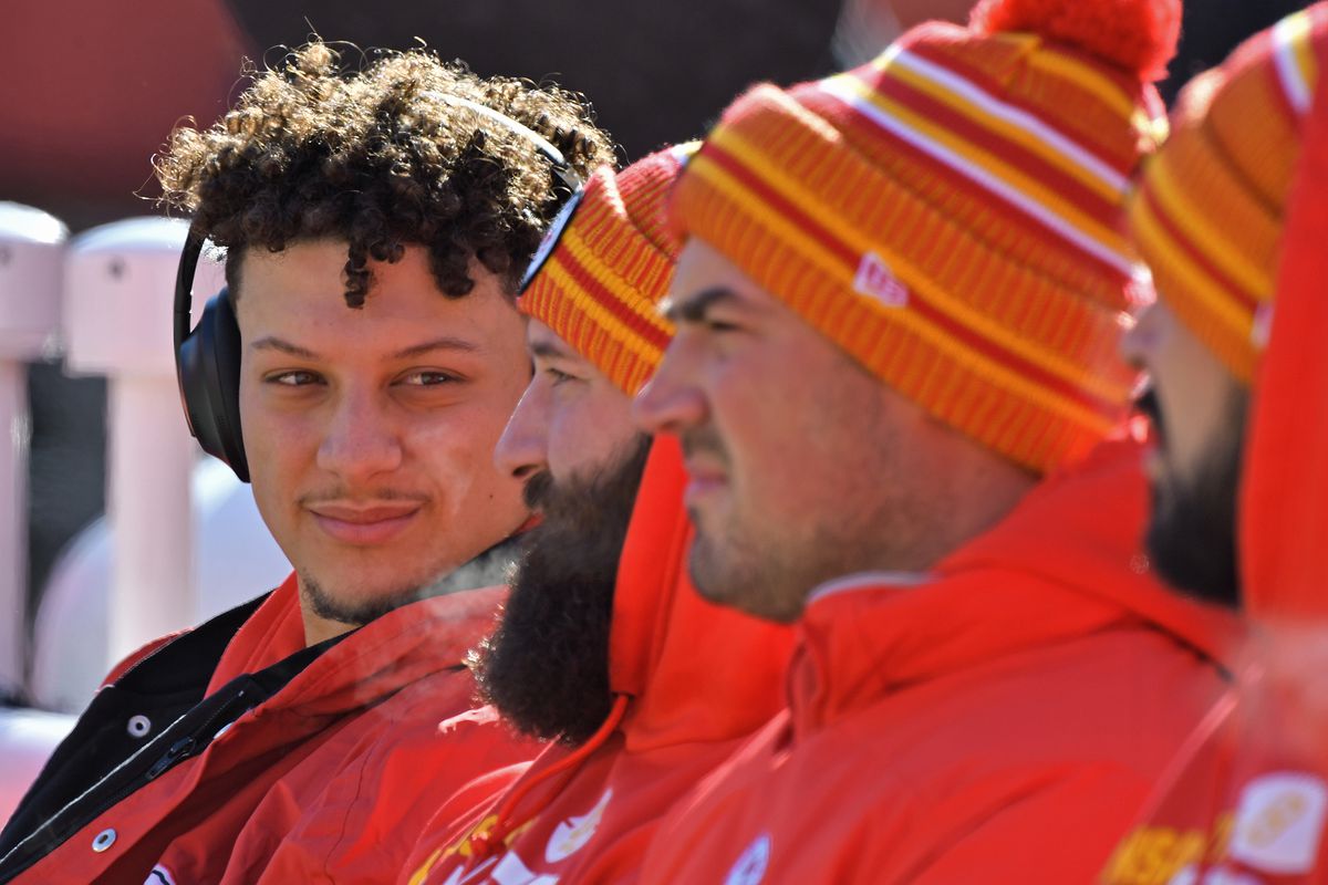 Quarterback Patrick Mahomes #15 of the Kansas City Chiefs talks with teammates on the bench, during pre-game activities before the AFC Championship Game against the Tennessee Titans at Arrowhead Stadium on January 19, 2020 in Kansas City, Missouri.