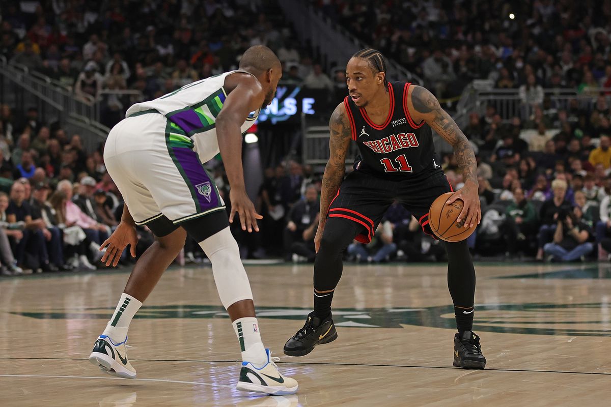 DeMar DeRozan #11 of the Chicago Bulls is defended by Khris Middleton #22 of the Milwaukee Bucks during the second quarter of Game One of the Eastern Conference First Round Playoffs at Fiserv Forum on April 17, 2022 in Milwaukee, Wisconsin.