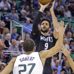 Minnesota Timberwolves guard Ricky Rubio (9) shoots as Utah Jazz center Rudy Gobert (27) defends during the first half in an NBA basketball game Friday, April 7, 2017, in Salt Lake City.