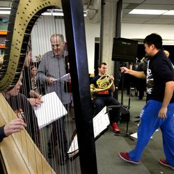 Students and teachers talk and clean up after an orchestra class at the Utah Valley University School of the Arts in Orem on Thursday, March 24, 2016.  