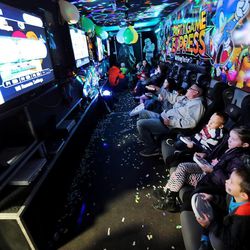 Kids and their parents play video games in the Party time Express at the Safe Kid Fair Friday, Feb. 20, 2015, at the South Towne Expo in Sandy.