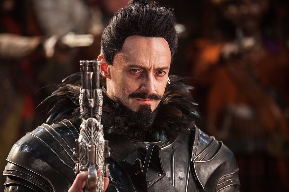 hugh jackman in pan with a gun and a black goatee