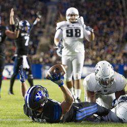 Brigham Young wide receiver Mitchell Juergens (87) signals a touchdown after catching a touchdown pass from quarterback Taysom Hill (7) during an NCAA college football game against Utah State in Provo on Saturday, Nov. 26, 2016. Brigham Young defeated in-state foe Utah State 28-10.