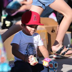 Joshua Escamilla plays with some toys as families choose from donated shoes, clothes and household items at Copperview Elementary in Midvale on Wednesday, Sept. 18, 2019.