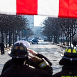 Chicago Fire Fighters salute as the procession for a off duty Chicago Police Officer who was fatally shot inside his car in the River North neighborhood arrives at the Cook County Medical Examiners Office, Saturday, March 23, 2019, in Chicago. | Tyler LaRiviere/Sun-Times