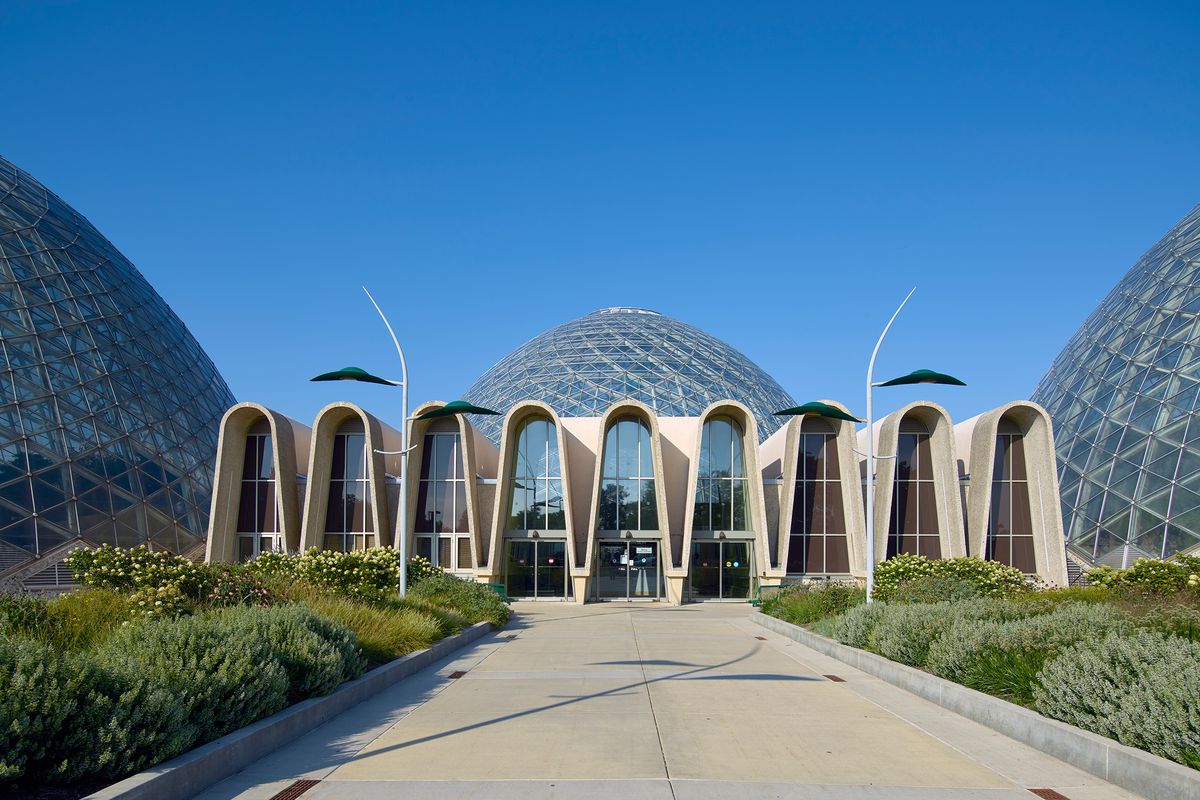 The exterior of the Mitchell Park Horticultural Conservatory. There are multiple glass domes. The entrance is a series of arches.