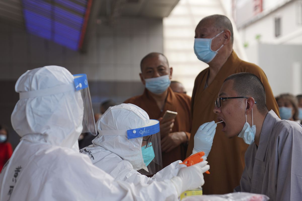Monks get tested for the coronavirus in a district in Guangzhou in southern China’s Guangdong province.