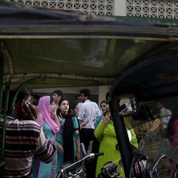 People evacuate buildings and gather on road as tremor of an earthquake was felt in Karachi, Pakistan, Tuesday, April 16, 2013. A major earthquake described as the strongest to hit Iran in more than half a century flatted homes and offices Tuesday near Iran's border with Pakistan, killing at least tens of people in the sparsely populated region and swaying buildings as far away as New Delhi and the skyscrapers in Dubai and Bahrain. (AP Photo/Shakil Adil)