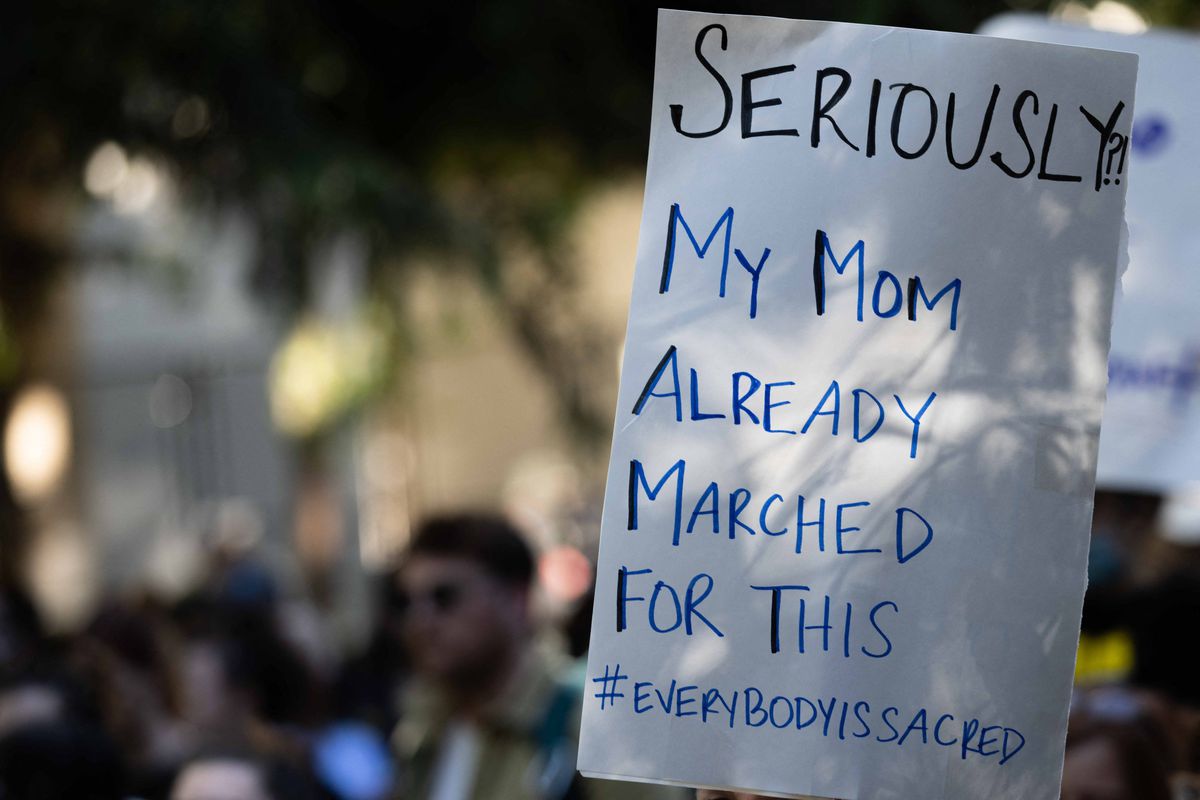 Aktivis hak aborsi muncul di Portland, Oregon, setelah Mahkamah Agung menjatuhkan Roe Vs.  Menyeberang.  Seseorang memegang papan bertuliskan, “Serius?!  Ibuku sudah berbaris untuk ini.”