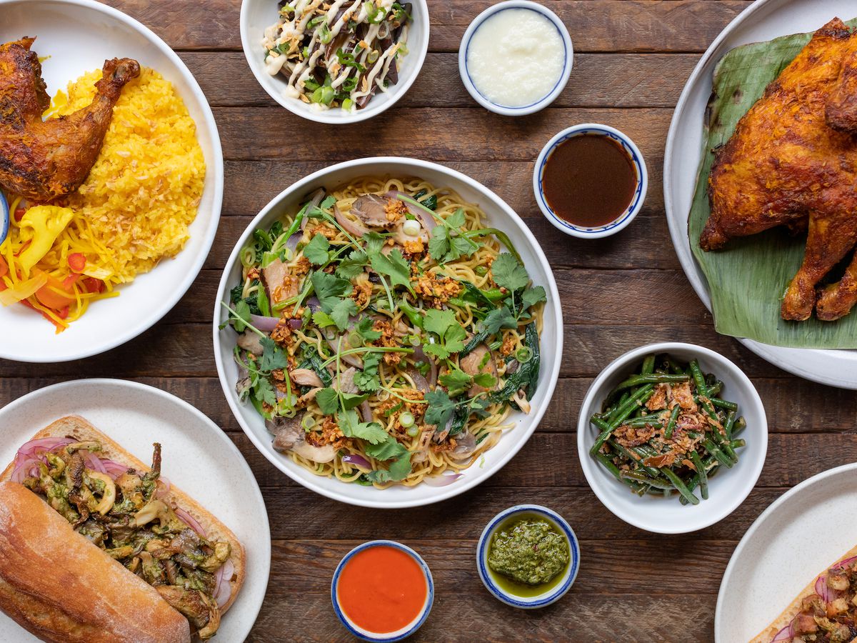 An overhead shot of bowls of Filipino food, including chicken and noodles.