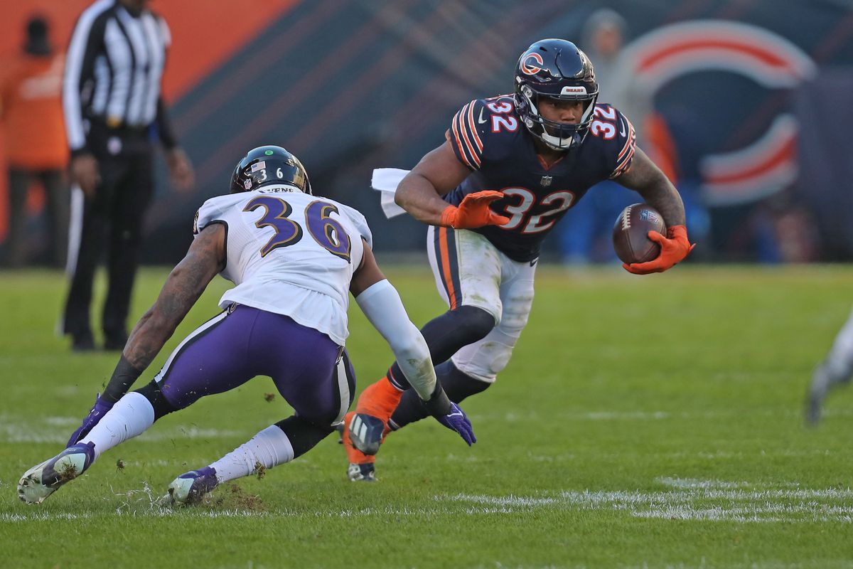 Chicago Bears running back David Montgomery (32) runs against Baltimore Ravens safety Chuck Clark (36) during second half at Soldier Field.